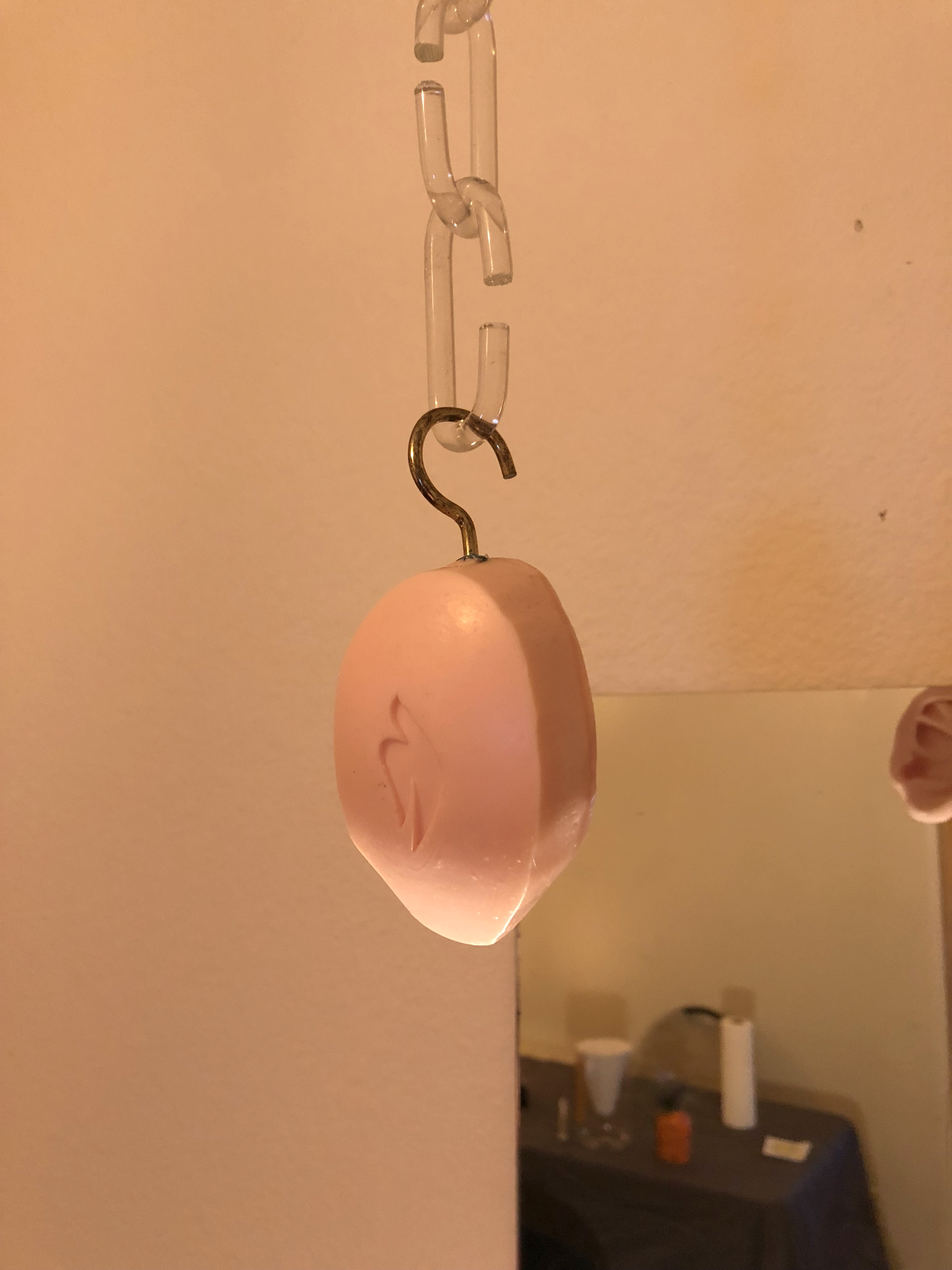 A dove soap bar hung from the ceiling by plastic chains